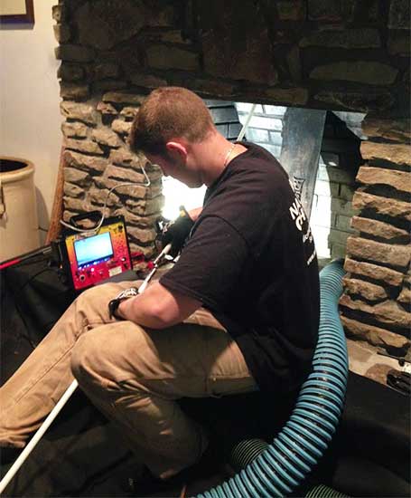 Traditions Chimney Sweep original photo of virtual inspection. Tech in process of virtual inspection.