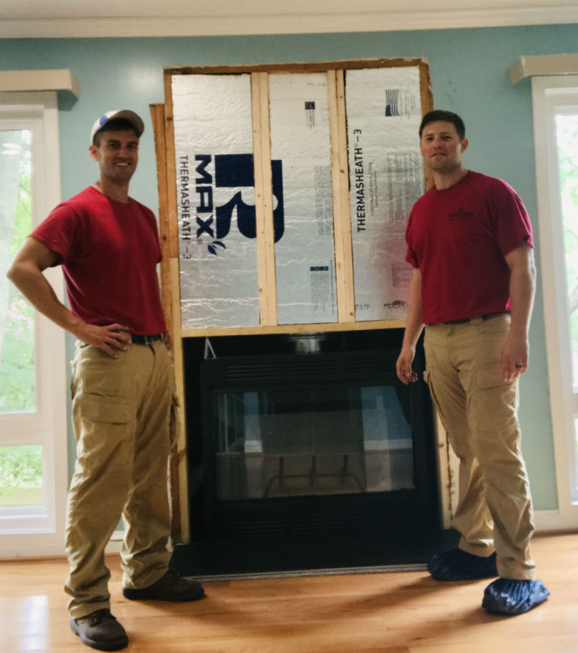Traditions Chimney Sweeps original photo of prefab installation with Nick and Chris. Nick and Chris standing in front of a prefab installation.