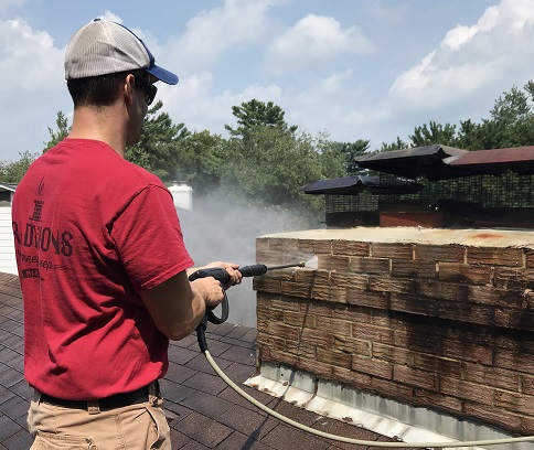 Tech spraying Water Repellent on Bricks.