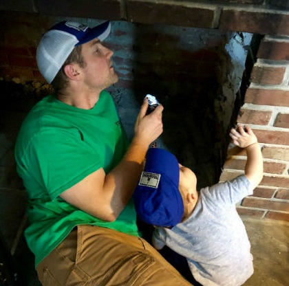 Chris with son inspecting a chimney.