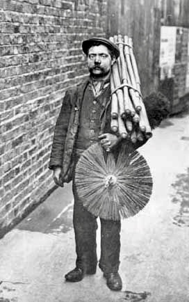 Vintage photo of a chimney sweep with brush and sticks.